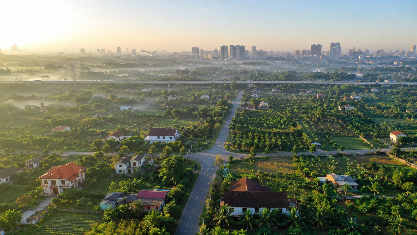 Bất động sản vùng ven Đồng Nai 2026 nhìn từ trên cao, vườn cây và đô thị phía xa